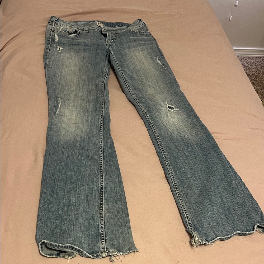 Silver Jeans Faded Blue Flare Jeans with Distressing